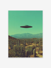 UFO flying saucer hovering over a desert landscape with saguaro cacti and mountains under a teal sky, surreal wall art.