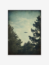 Vintage style UFO flying saucer in a muted blue sky framed by dark trees. Mysterious sci-fi wall art print.