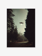 Vintage style photographic print of a UFO with a light beam hovering over a dark tree-lined path.
