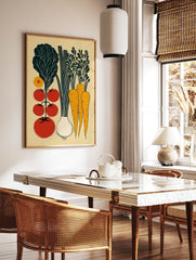 A vegetable garden poster featuring a vintage illustration of tomatoes, lettuce, carrots, and an onion in a light wood frame.