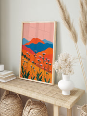 Vibrant abstract landscape wall art depicting a field of pink and white flowers, green stems, orange hills, and blue mountains. - Image 3