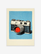 Illustrated vintage camera art print on a light blue background with a red lens, perfect for retro wall decor.