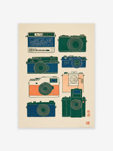 An illustration of eight vintage cameras in blue, green, and orange colors on a light background, ideal for camera wall art.