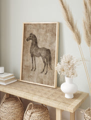 Sepia sketch of a horse standing in profile on a textured beige background, vintage, in an alternate framed mockup