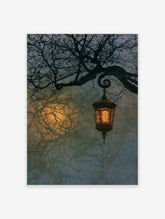 Vintage lantern hanging from a dark, gnarled tree branch against a hazy, moonlit night sky art print