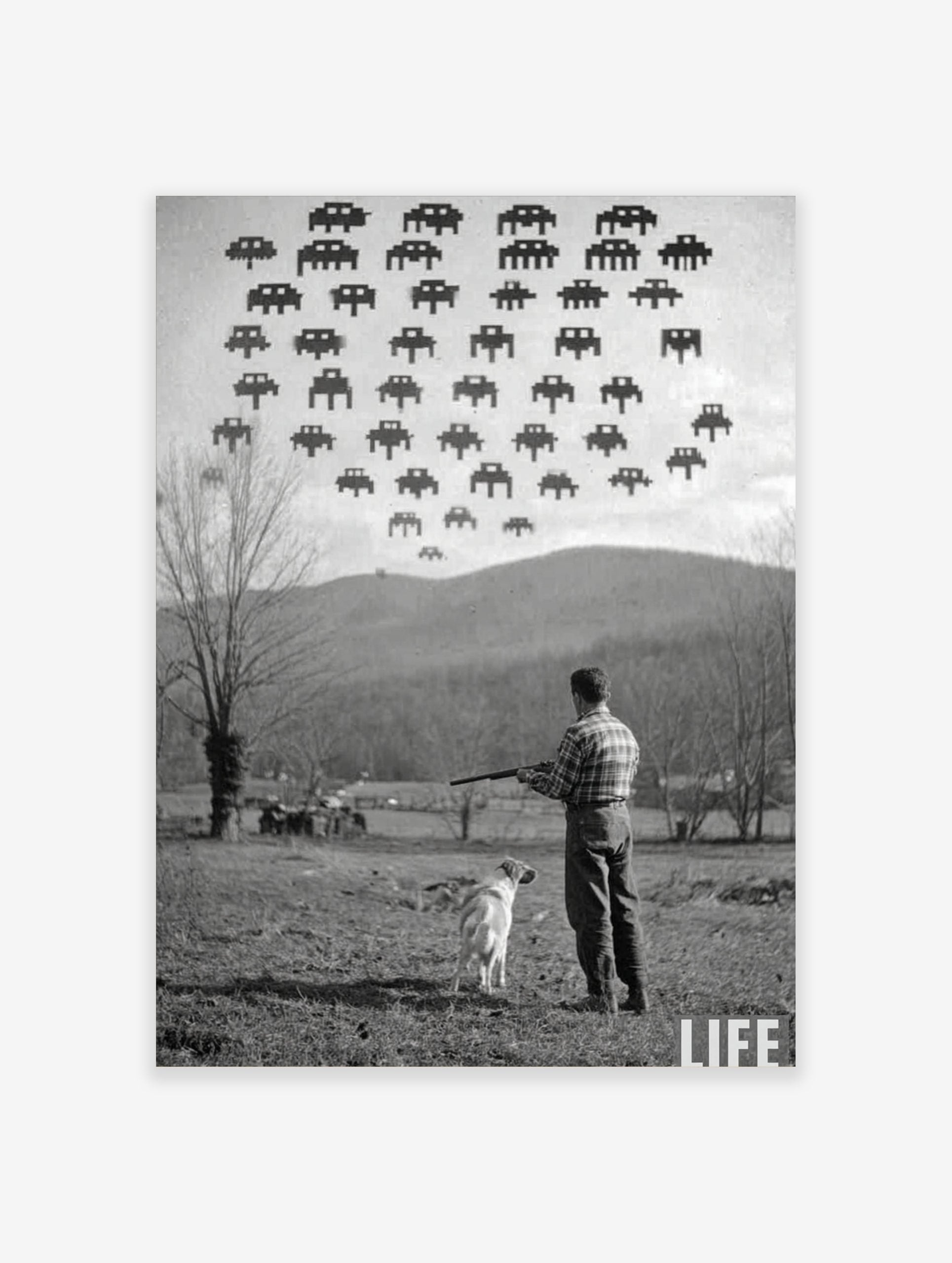 Monochrome photographic print of a man and dog looking up at pixelated Space Invaders in the sky