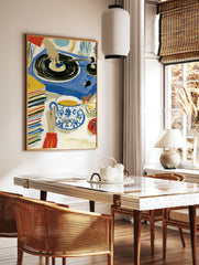 Illustrative art print of a hand on a vinyl record player with tea and a stack of records in blue, in a styled room mockup