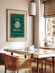 Viva Mexico wall art with eagle and serpent emblem, 'VIVA MEXICO' text, green background, and red, in a styled room mockup