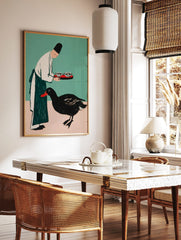 Illustrative print of person in chef's hat holding tray for black duck with red beak on teal and, in a styled room mockup