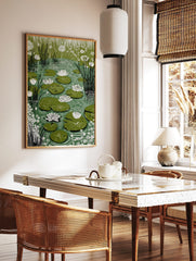 Illustrative water lily pond print with white water lilies, green lily pads, and tall reeds in a, in a styled room mockup