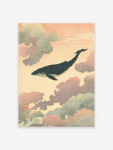 Japanese-style whale wall art print with a dark whale swimming through pink and blue clouds with gold speckles.