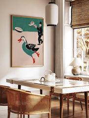 Whimsical illustrative print of a running teal duck with red beak and a waiter carrying a lidded, in a styled room mockup