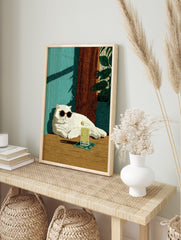 Illustrative print of a white cat in sunglasses with a lime drink, against a teal wall and, in an alternate framed mockup