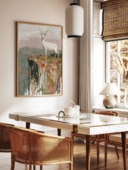 White deer with antlers standing on a cliff edge with orange and yellow grasses in a painterly style, in a styled room mockup