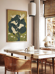 Illustrative art print of five white egrets with leafy branches in a dark green tree, with gold, in a styled room mockup