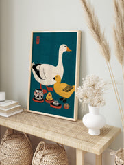Illustrative print of a white goose, yellow duck, and ceramic pots on a teal background with, in an alternate framed mockup