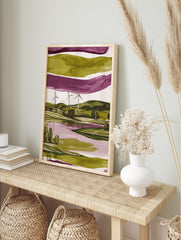Modern abstract landscape art print with three wind turbines, green hills, and a purple lake, in an alternate framed mockup