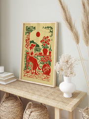 Illustrative print of a woman in a hat reading by the sea with red sun and potted flowers in, in an alternate framed mockup
