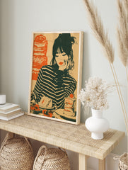Vintage illustrative art print of a woman in a striped shirt looking at a cake and, in an alternate framed mockup
