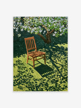 Wooden chair resting on green grass under a blooming white tree, casting dappled shadows on the lawn