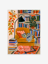 Illustrative yellow armchair wall art with bookshelf and trailing leaves