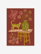 Yellow cat wall art illustration with a green vase, pink flowers, and a table on a reddish-brown background.