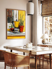 Illustrative print of a yellow moka pot and striped coffee cup with potted green plants on a, in a styled room mockup