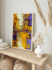 Abstract painting with bold yellow and deep purple textured brushstrokes, accented with white, in an alternate framed mockup
