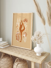 Terracotta yoga dancer pose silhouette with cream botanical illustrations on a beige, in an alternate framed mockup