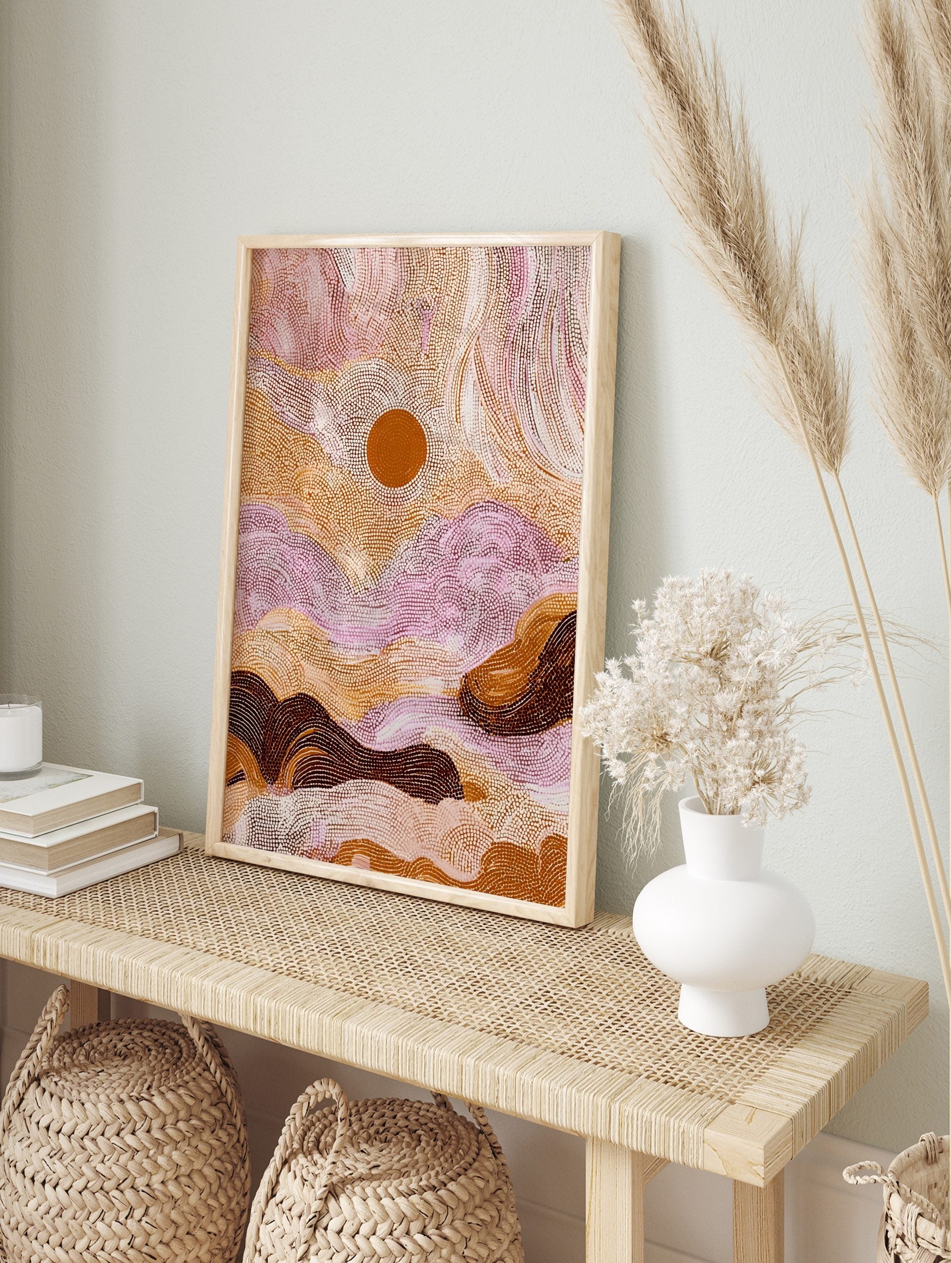 Aboriginal dot painting wall art with abstract desert landscape, central orange sun, earthy, in an alternate framed mockup