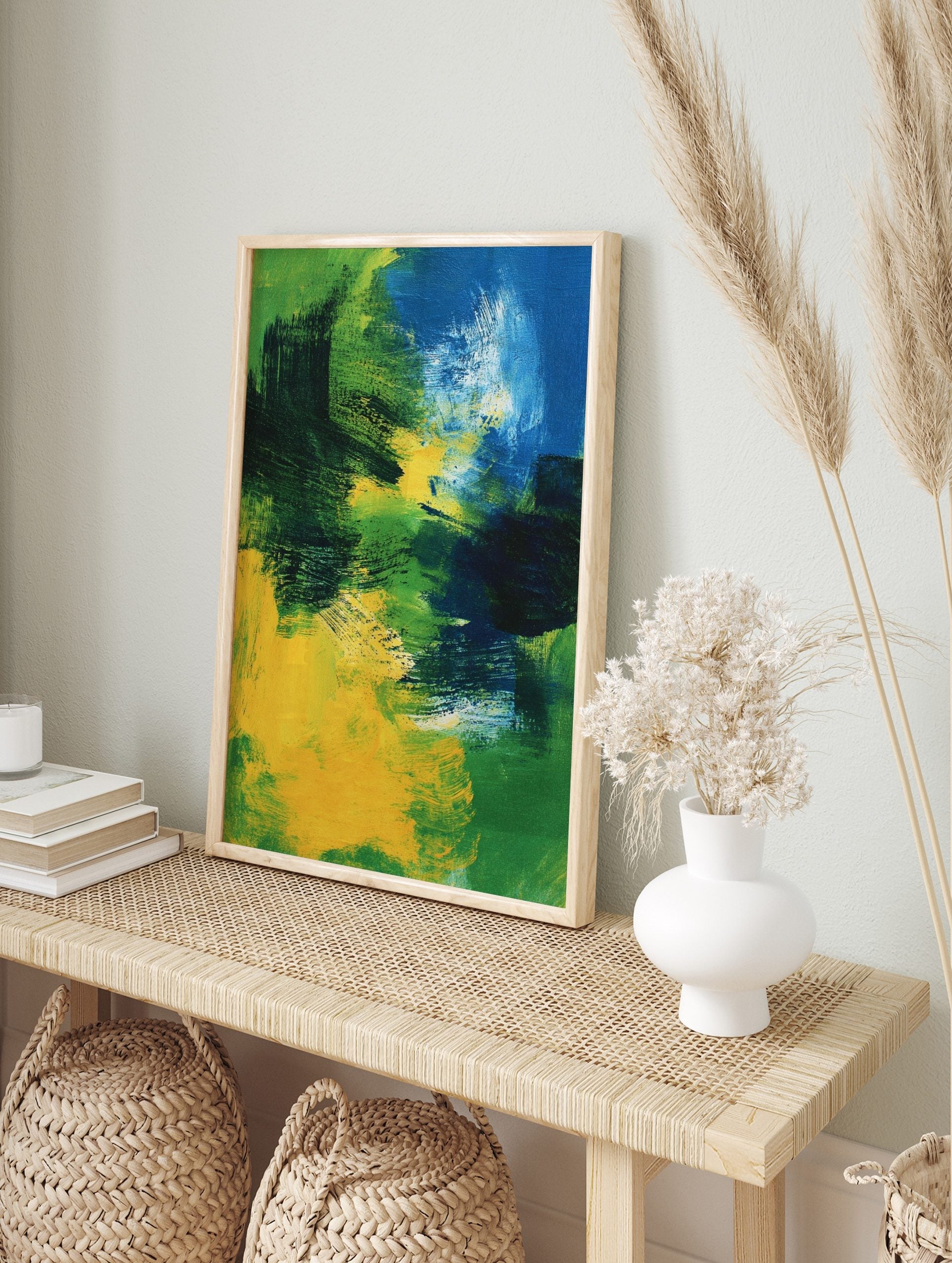 Abstract painting with bold brushstrokes in shades of blue, green, and yellow, creating, in an alternate framed mockup