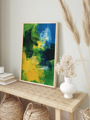 Abstract painting with bold brushstrokes in shades of blue, green, and yellow, creating, in an alternate framed mockup