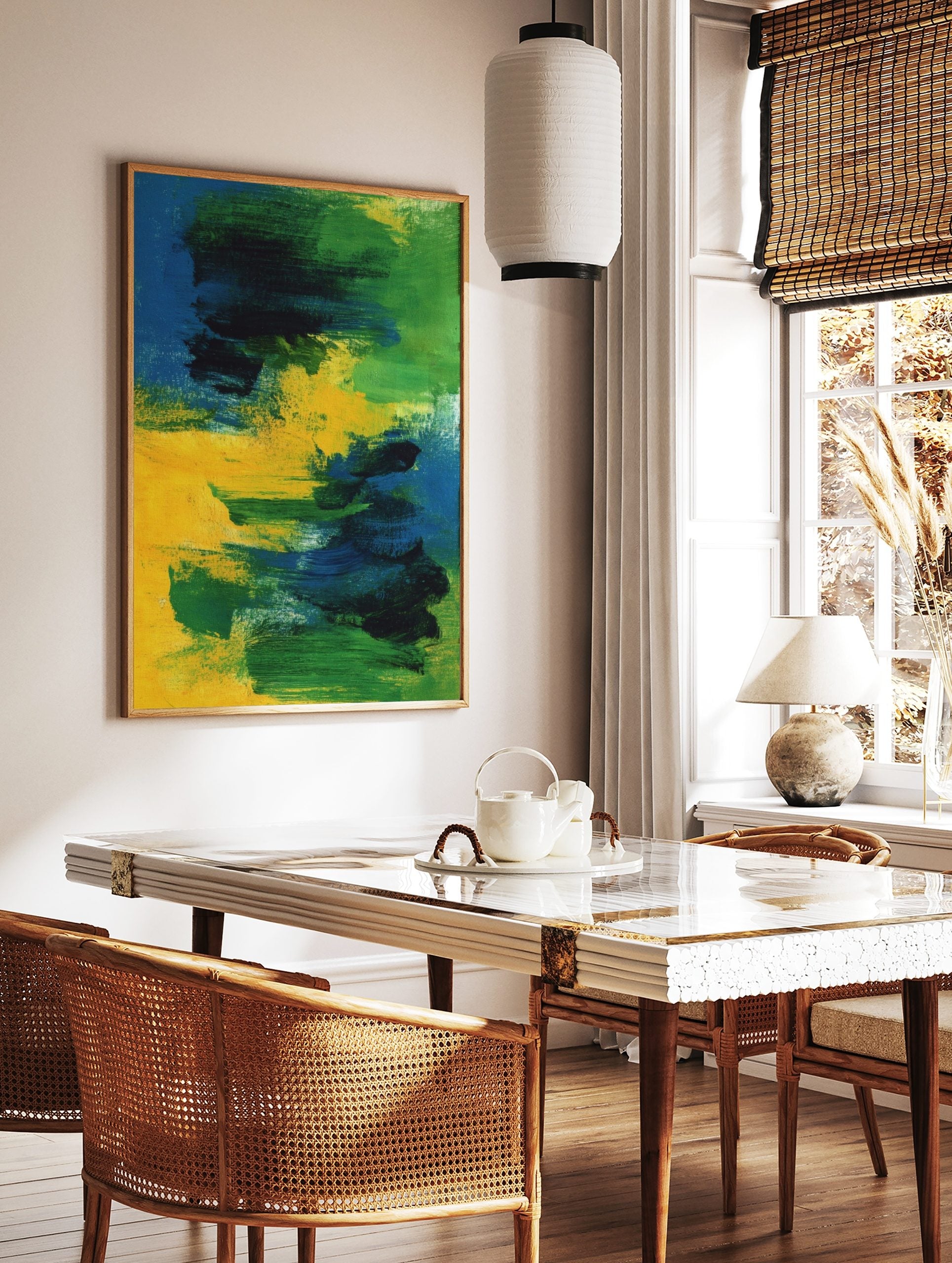 Abstract painting with bold blue, green, and yellow brushstrokes on canvas, creating a dynamic, in a styled room mockup