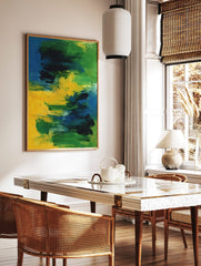 Abstract painting with bold blue, green, and yellow brushstrokes on canvas, creating a dynamic, in a styled room mockup