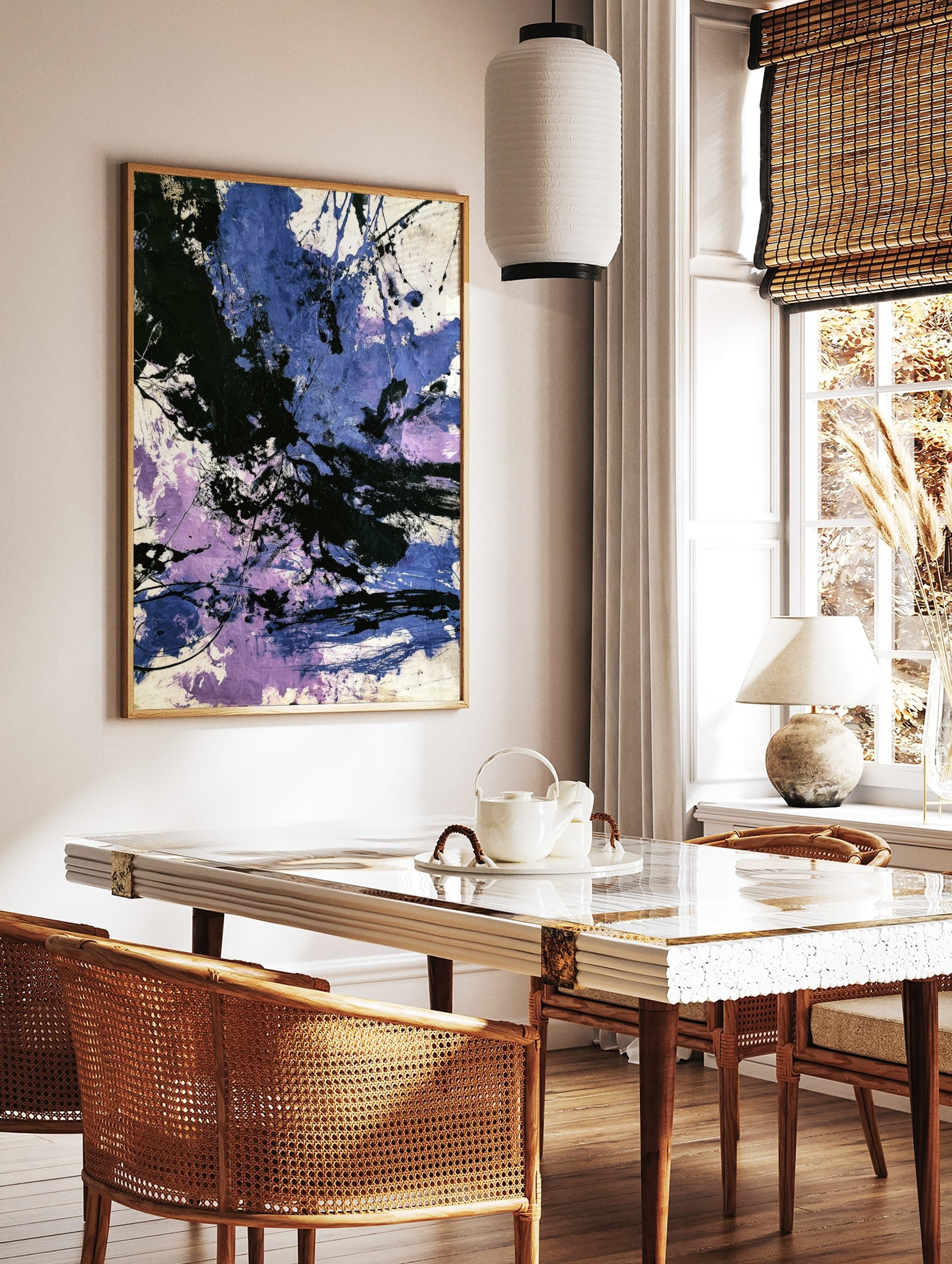 Abstract painting with dynamic black, blue, and purple paint splashes and energetic brushstrokes on, in a styled room mockup