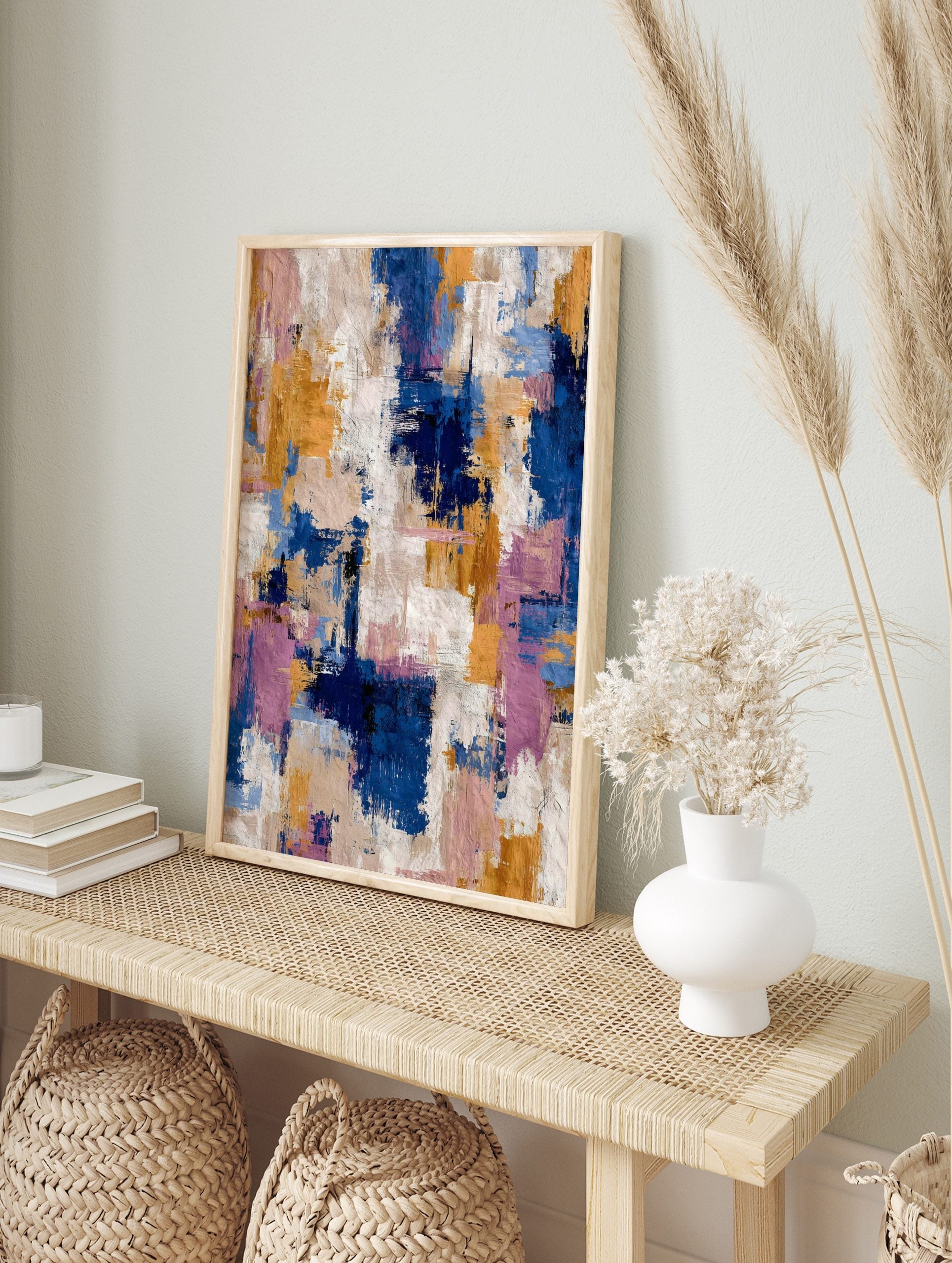 Abstract art print with blue, gold, pink, and white textured brushstrokes in a dynamic, in an alternate framed mockup