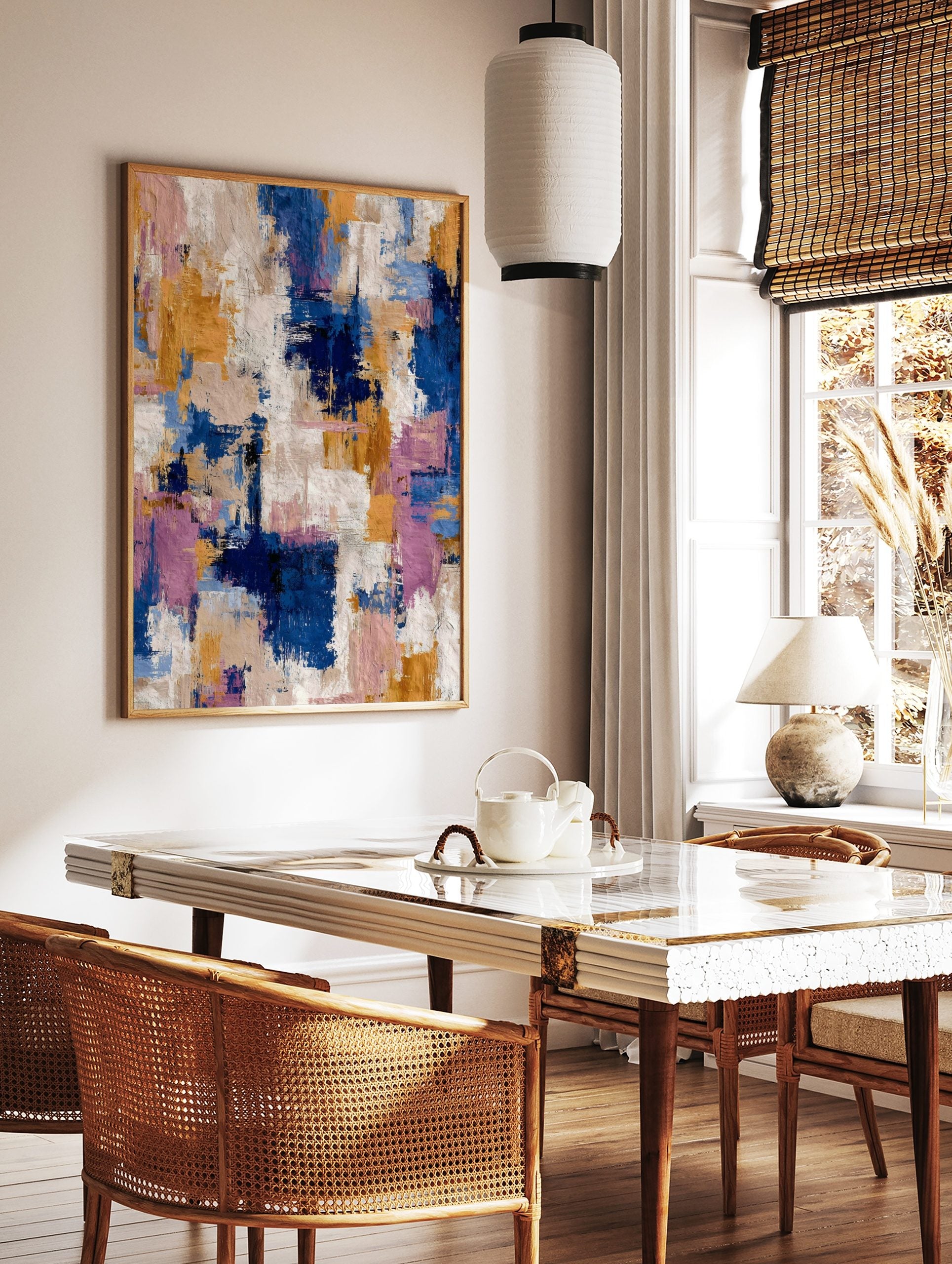 Abstract art print with blue, gold, pink, and white textured brushstrokes in a dynamic vertical, in a styled room mockup