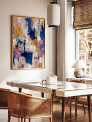 Abstract art print with blue, gold, pink, and white textured brushstrokes in a dynamic vertical, in a styled room mockup