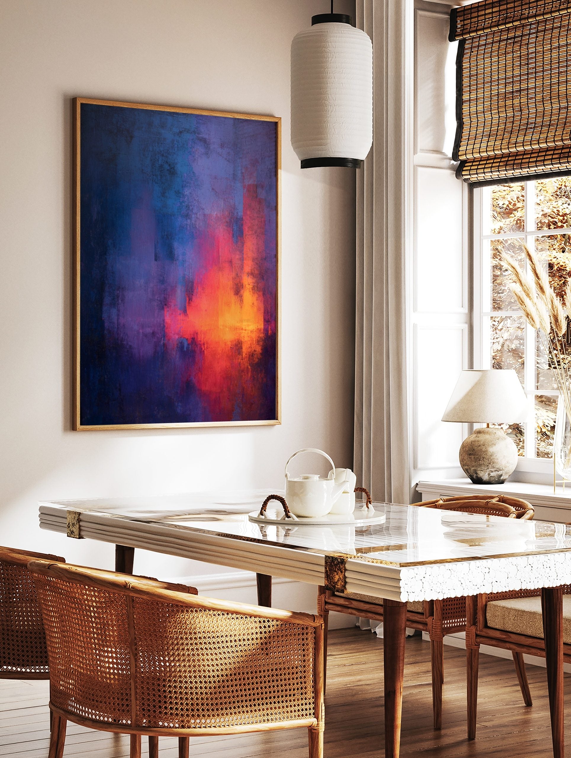 Abstract painting with vertical streaks of blue, purple, red, and orange, showing textured, in a styled room mockup