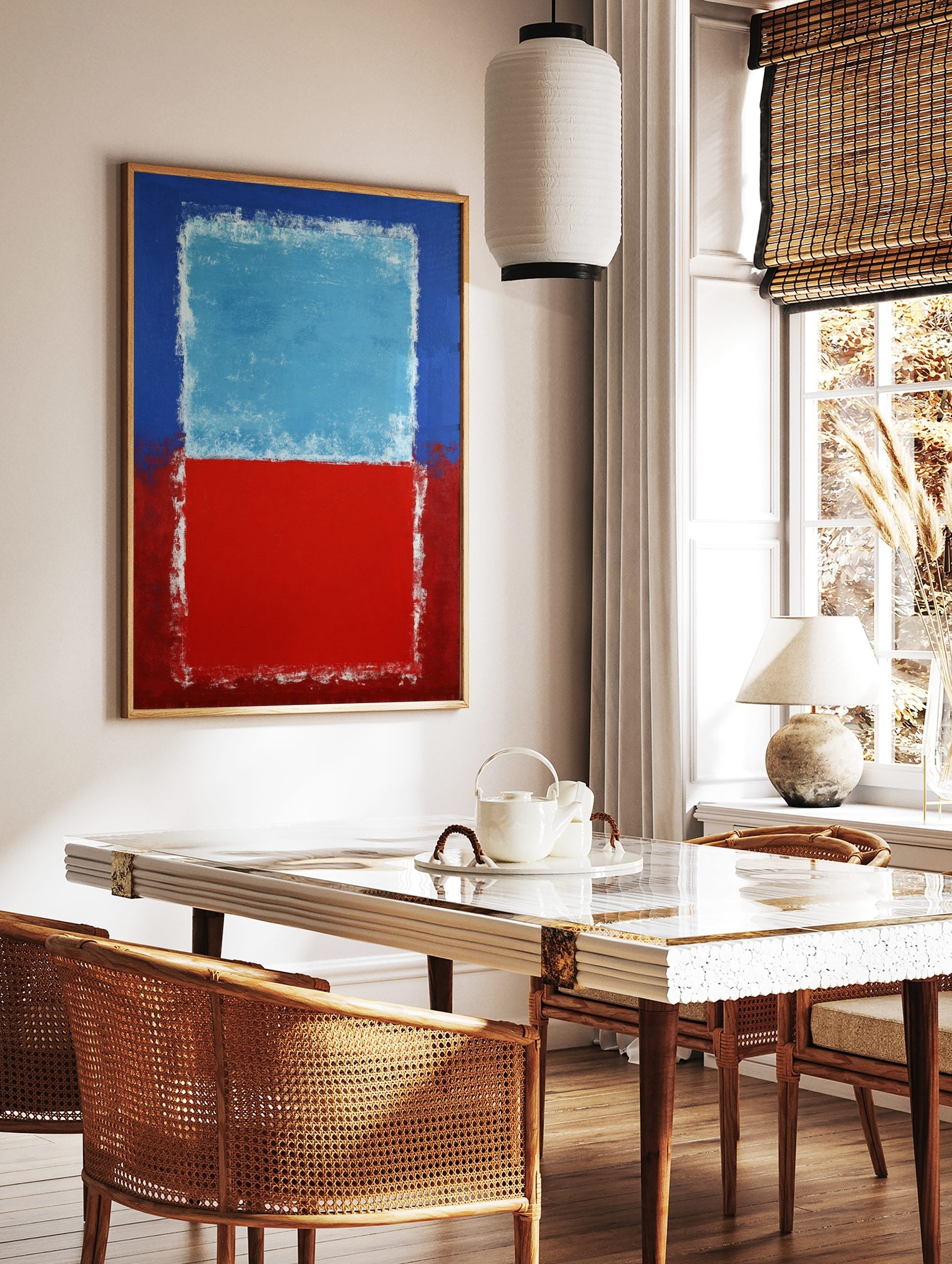 Abstract art print with a light blue rectangle over a red rectangle, bordered by darker blue and, in a styled room mockup