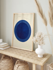 Minimalist abstract art print with two concentric blue circles on a white background, in an alternate framed mockup