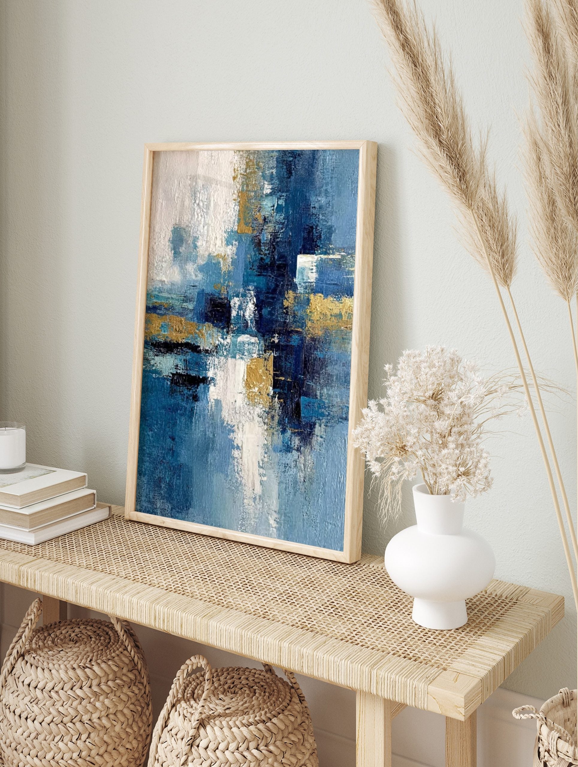 Abstract art print with textured blue, white, and gold brushstrokes in a dynamic vertical, in an alternate framed mockup