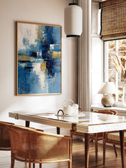 Abstract art print with textured blue, white, and gold brushstrokes in a dynamic vertical, in a styled room mockup
