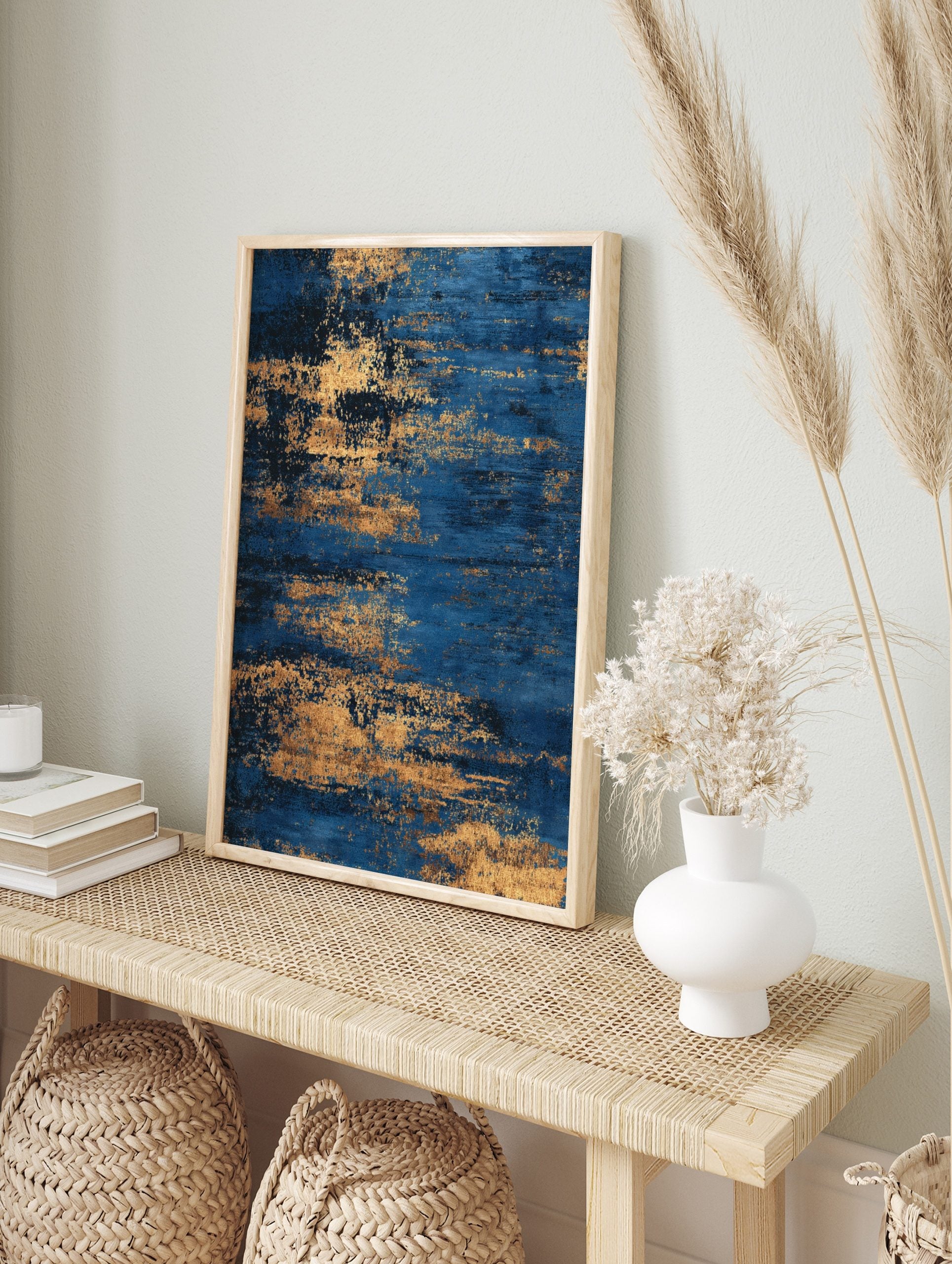 Abstract blue and gold textured wall art print with horizontal streaky patterns, in an alternate framed mockup