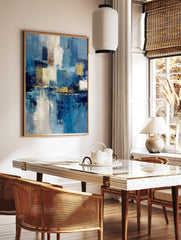 Abstract blue, white, and gold textured painting with layered blocks of colour and a reflective, in a styled room mockup