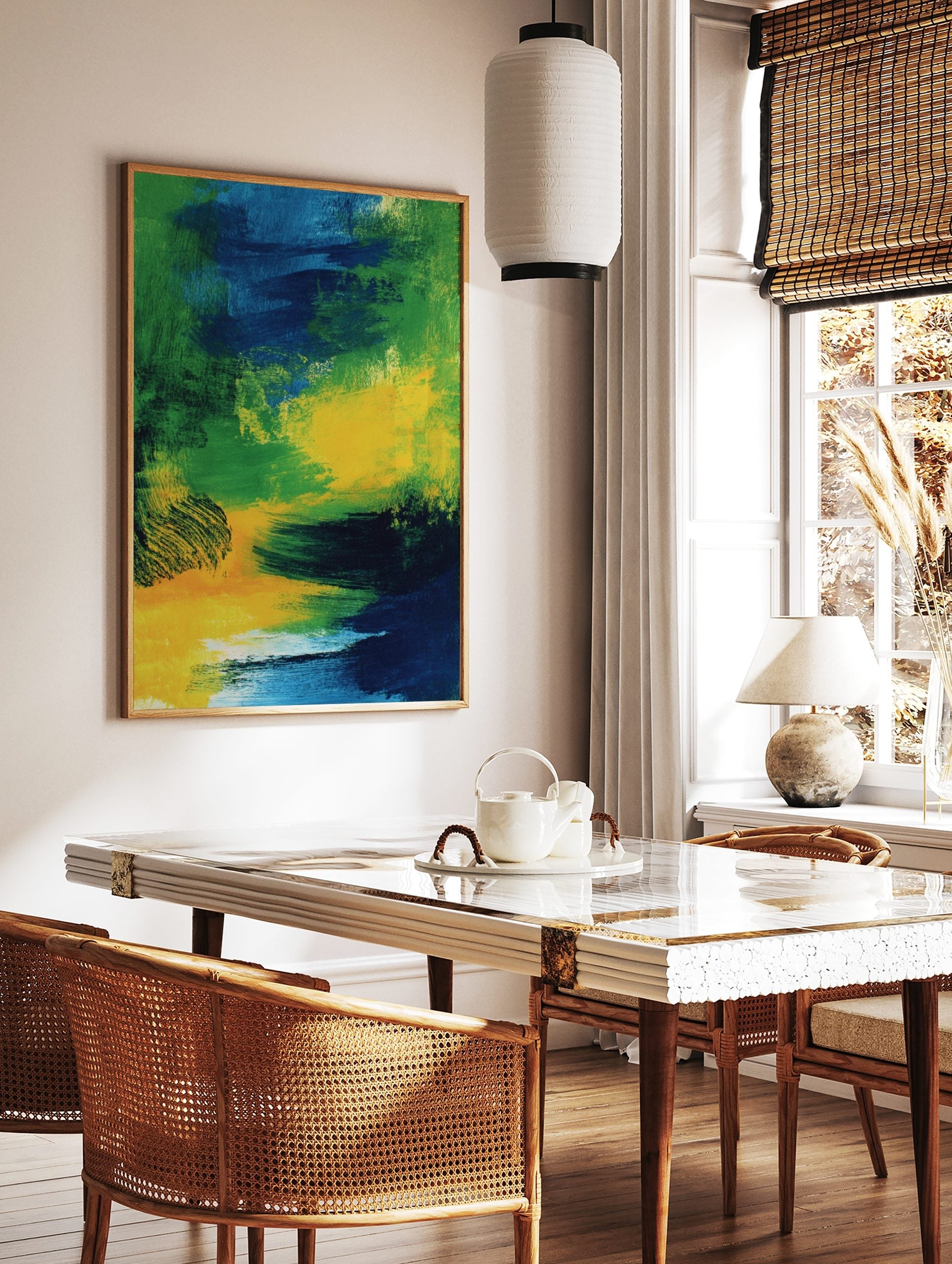 Abstract art print with bold, sweeping brushstrokes in green, blue, and yellow colours, in a styled room mockup