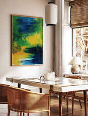 Abstract art print with bold, sweeping brushstrokes in green, blue, and yellow colours, in a styled room mockup