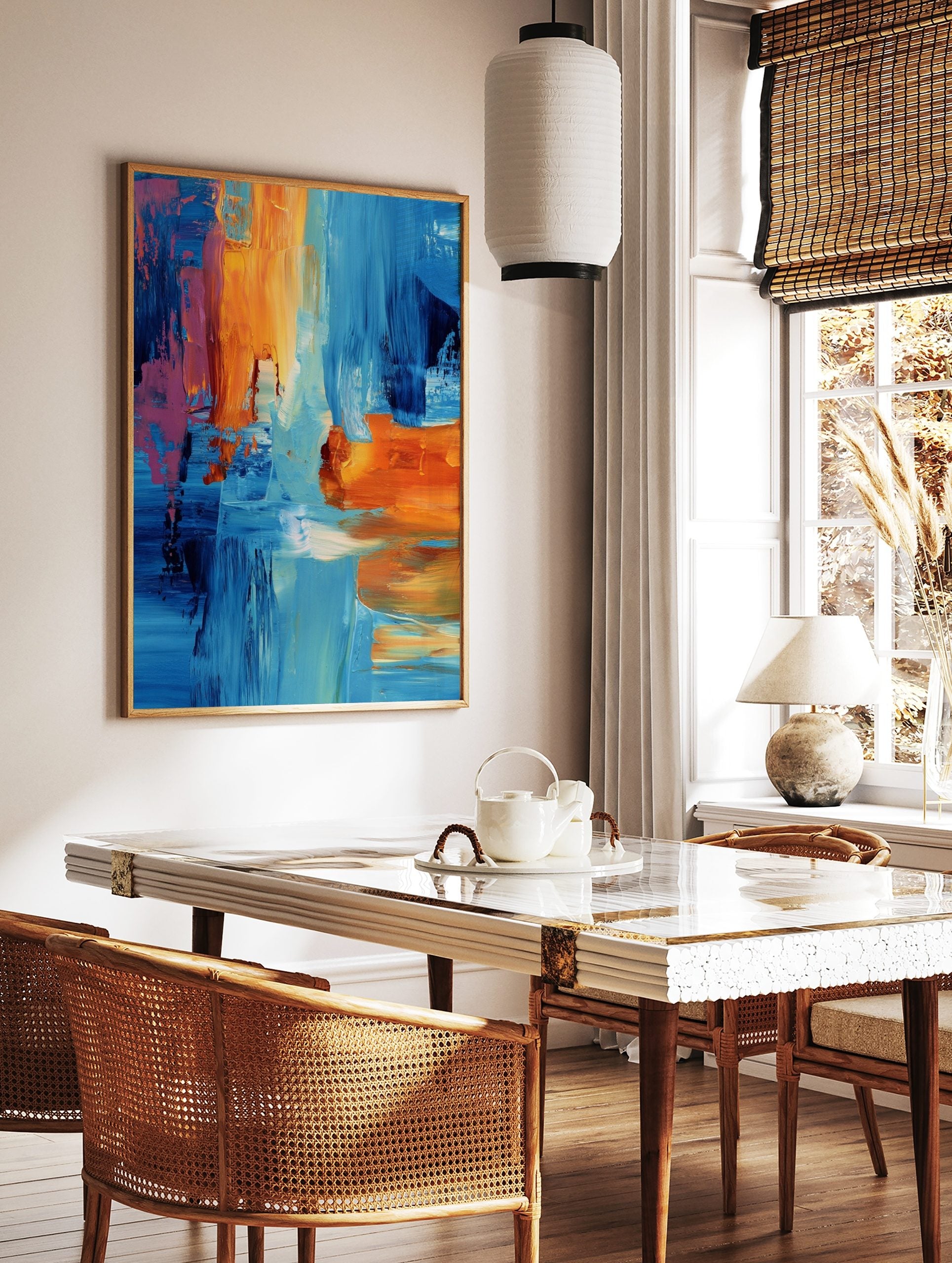 Abstract art print with bold blue, orange, and pink brushstrokes creating layered textures, in a styled room mockup