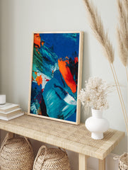 Abstract painting with textured blue, orange, and green impasto brushstrokes on canvas, in an alternate framed mockup