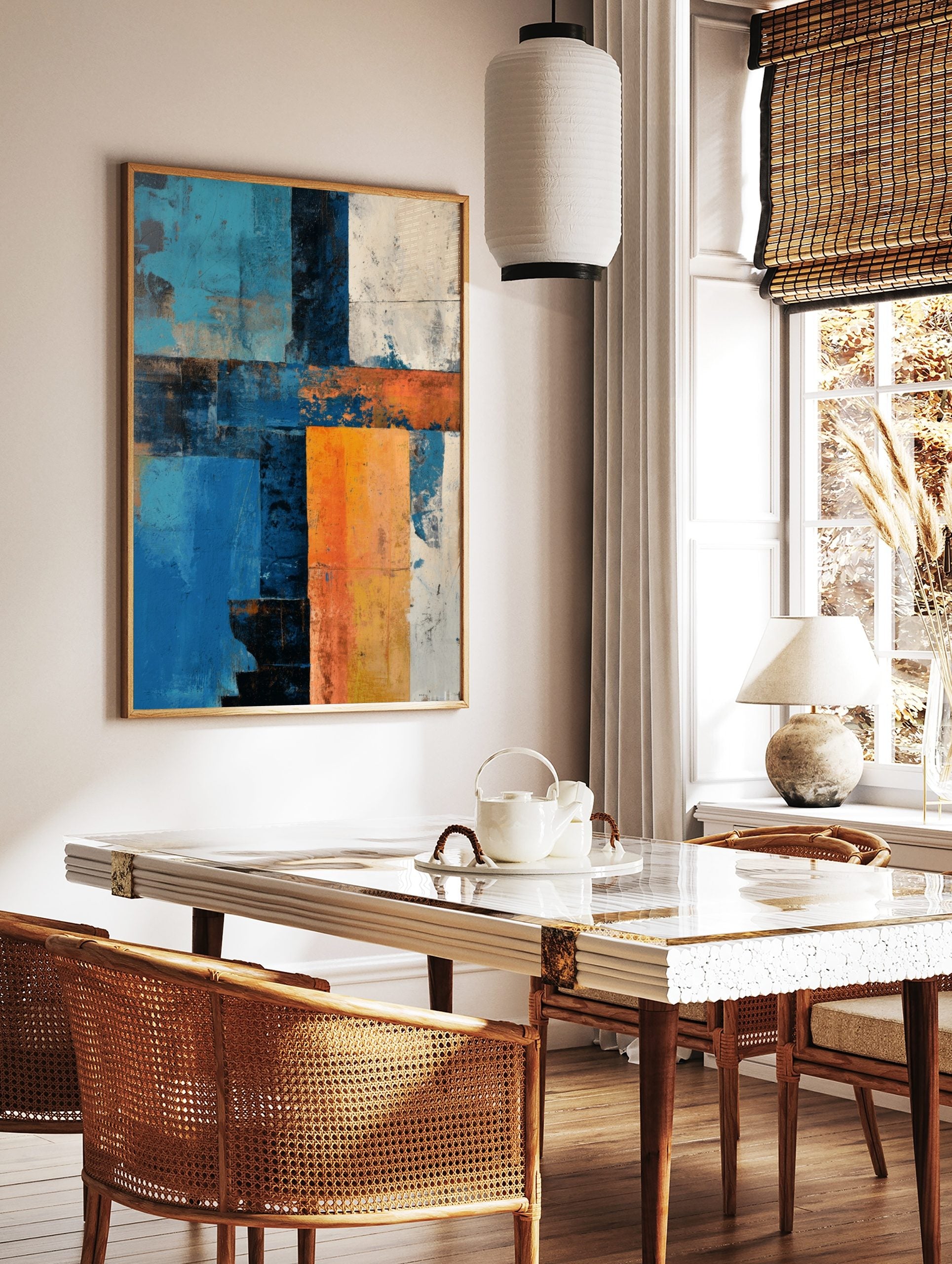 Abstract art print with textured blocks of blue, orange, white, and dark tones in a grid-like, in a styled room mockup